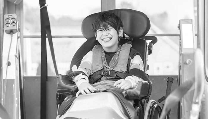 Kind im Rollstuhl lacht